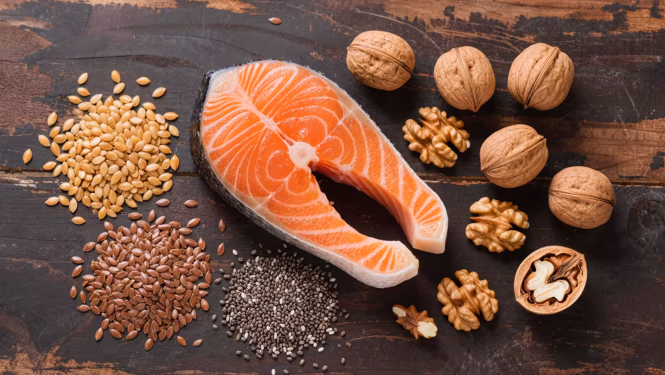 Flat lay of salmon fillet, walnuts, flax seeds, chia seeds on rustic wooden surface